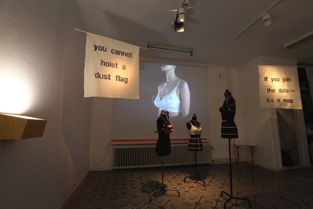 installation view&amp;ndash; letterpress print banners, brassiere text work, projection